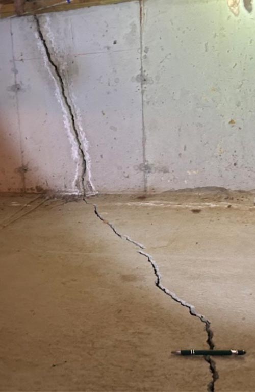 Big foundation crack through floor slab and continuing up through wall